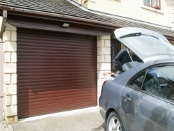 Powdercoat brown insulated roller shutter installed on brickwork