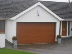 Ribbed sectional garage door in decograin golden oak to provide a natural wooden effect