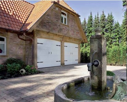 Twin steel sectional garage doors in the style of traditional side-hinged garage doors