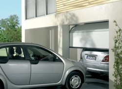 Space-efficient sectional garage doors allow for additional driveway space