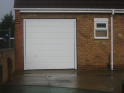 Plain white sectional garage door with a white handle available as an optional extra