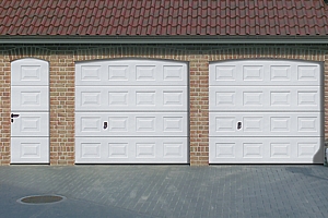 Matching twin georgian style sectional garage doors with matching panelled side door