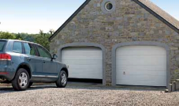 hormann steel sectional white twin garage door in arches with jeep