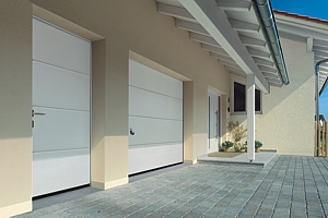sectional garage door with matching side entrance door and front door for the home