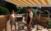 Patio Awning providing sun shade over social bbq event