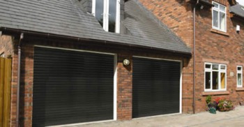 two matching black single seceuroglide roller shutter garage doors installed on home