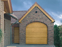 Hormann LTH S Ribbed Nordic Pine sectional timber garage door in arched opening