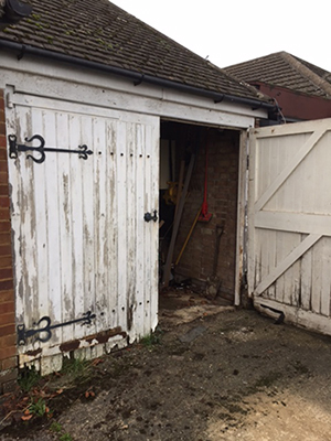 Old and warn side hinged garage door