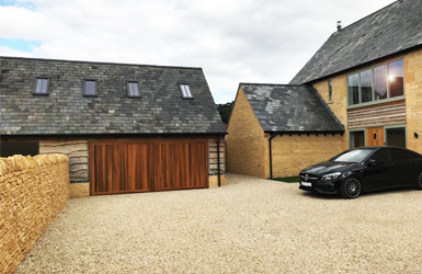Woodrite Cedarwood Double Chalfont Up and Over Garage Door finished in Light Oak