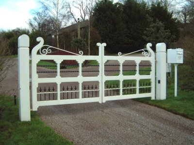 Pair of white painted timber estate gates with hydraulic ram automation
