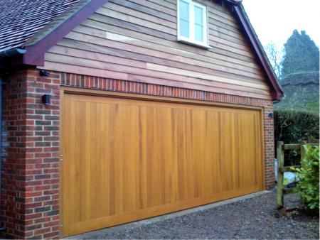 Cedar Bakewell Cedar wood timber door installed inbetween double brick garage with cedar clad sub frame