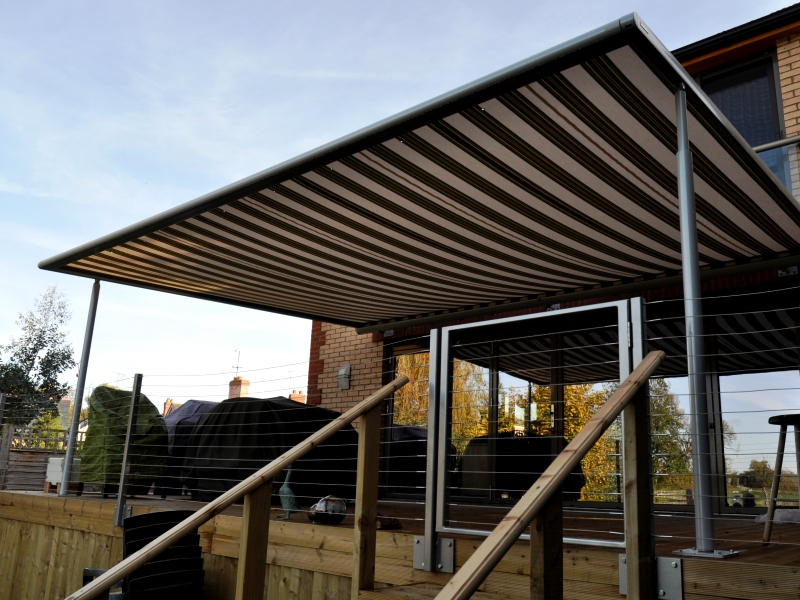 Brown and Cream striped Markilux Pergola terrace cover on decking