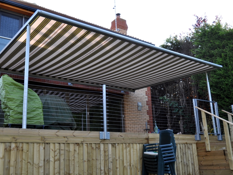 Brown and Cream striped Markilux Pergola terrace cover on decking