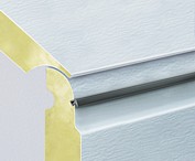 Sectional door panels have a seal inbetween each panel