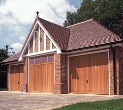 Triple garage with Garage Light and 2 Berkeley Vertical cedar timber garage doors