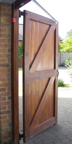 Side hinged garage door with operator 