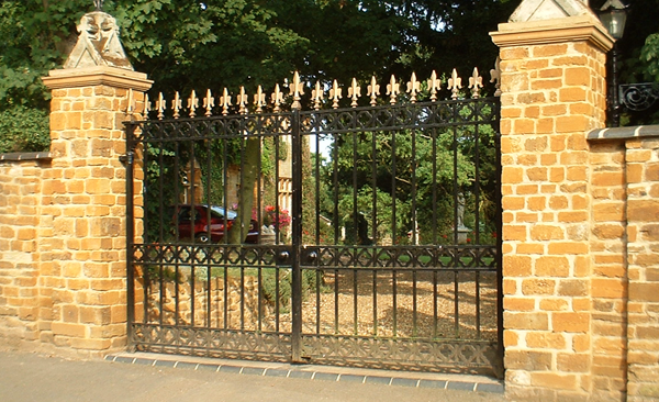 fancy steel entrance gates with gold and black paint finish