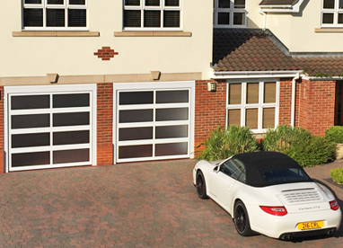 pair of opaque glazed sectional doors with white framework