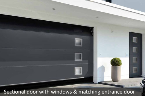 Hormann sectional garage door with windows and matching entrance door 