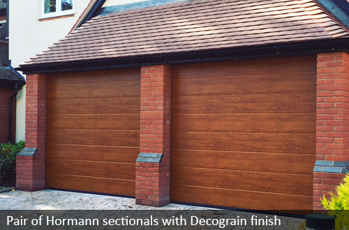 Pair of Hormann sectional doors with wood effect finish 