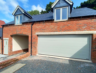 Pebble grey sectional garage door matching front door