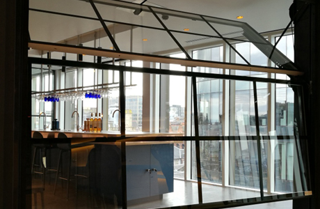 An overlap glass trackless door in a whisky distillery