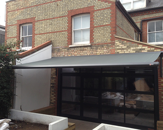 Glass sectional door with awning
