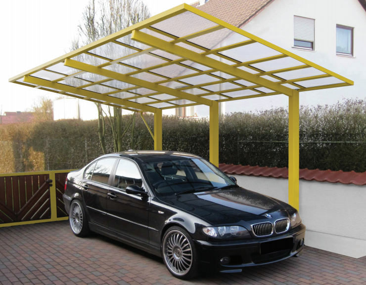 A yellow framed Ryterna Carport sheltering a BMW on a driveway