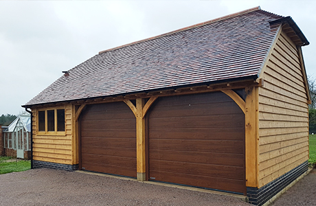 Traditional Oak garage with insulated wood effect finish doors