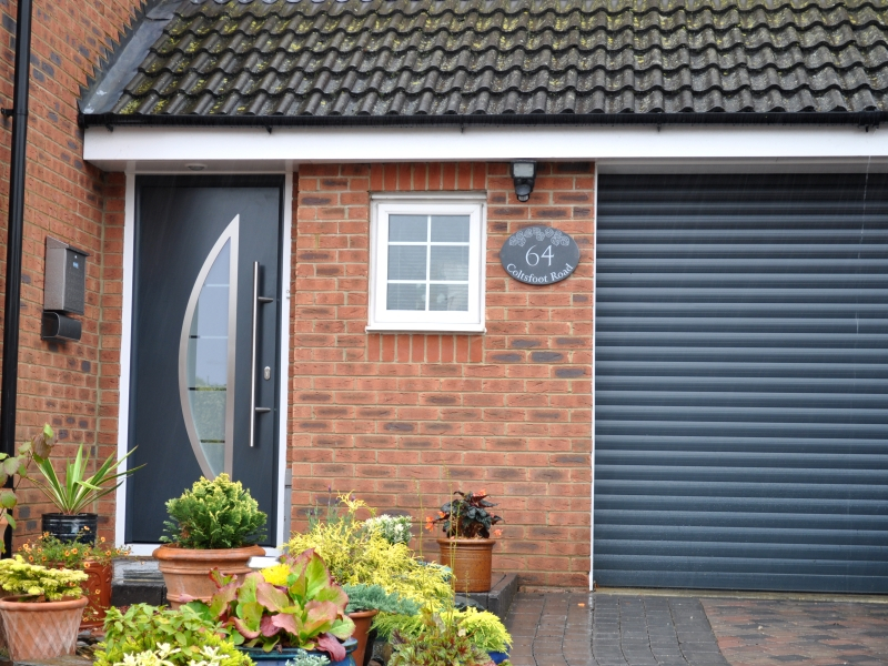 Hormann ThermoPro Entrance Door (Style 700) in Anthracite Grey (RAL 7016) with matching Sectional Garage Door. 